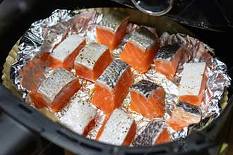Delicious salmon fillets cooking in foil. Healthy and easy meals from air fryer