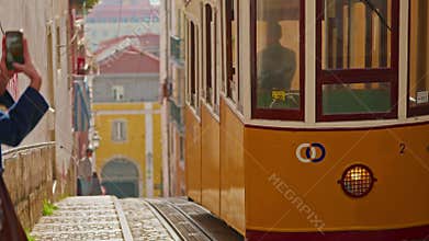 Yellow retro tram on the street of Lisbon as a tourist magnet and symbol of the city Lisbon Portugal