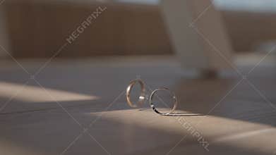 Wedding rings on the table. The ring is spinning.