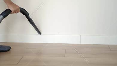Cleaning corners with a vacuum in a modern home