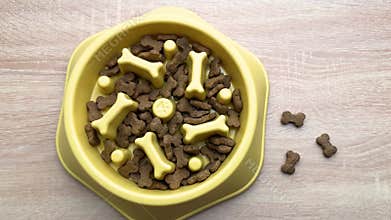 Dog food slowly disappearing from a slow feeder bowl