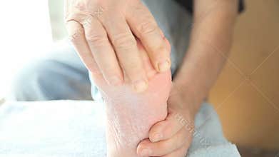 Man massages ball of foot