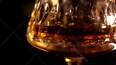 Whiskey in a glass slowly