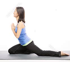 Young woman doing yoga exercise on mat