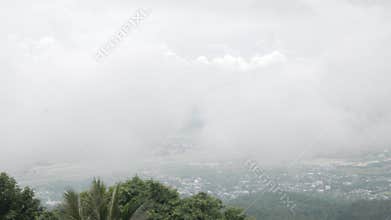 view of the local city of chiangmai from mountain hill under the cloud and fog level