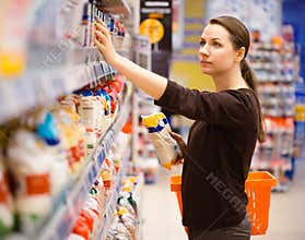 Young woman shopping for cereal, bulk in a grocery supermarket