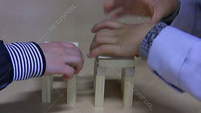 Kids building tower from toy blocks