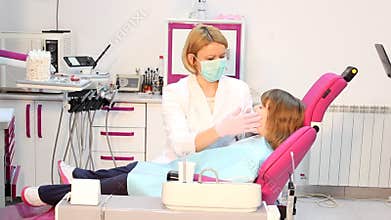Dentist examines teeth
