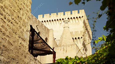 Fortified wall and a tower with battlement of the Palais des Papes in Avignon, France