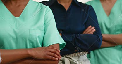 Diverse Medical Team: Doctors and Nurses United with Arms Crossed, Symbolizing Teamwork and Collaboration in Healthcare