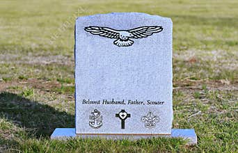 Old tombstone with engraved eagle, USN, scouts,