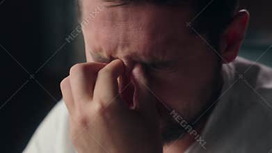 Sleepy Caucasian designer worker close up businessman man take off glasses pain myopia in office overworked guy