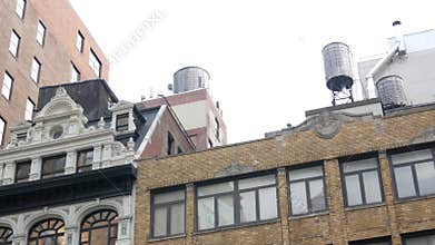 New York City building architecture. Residential house exterior. USA real estate. Rooftop water tower