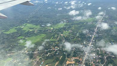 Aerial view from airplane Clouds Drifting Over a Rural Valley Town