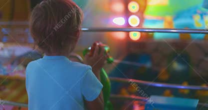 Child playing water gun game at arcade