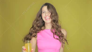Happy woman partying with a drink in her hand
