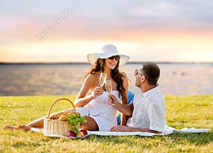Happy couple drinking champagne on picnic