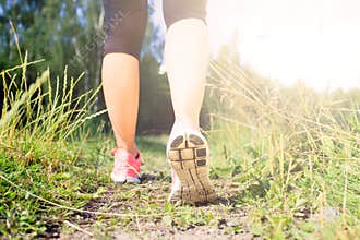 Walking or running legs in forest, adventure and exercising