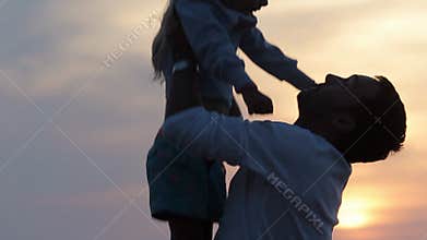 Close up of father throwing up his daughter in the