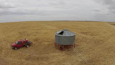 Aerial footage of farmer with silo on rural farm