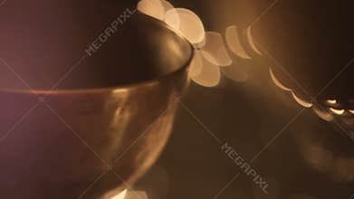 Holds a mallet to Tibetan singing bowl throat, defocusing