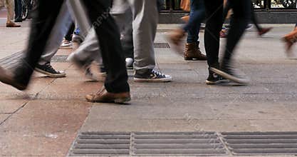 Crowd of anonymous blured people walking on busy street