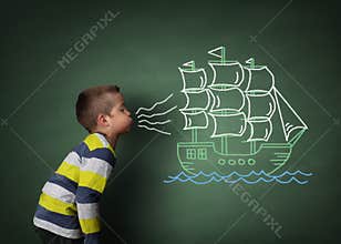 Child blowing a chalk sailboat