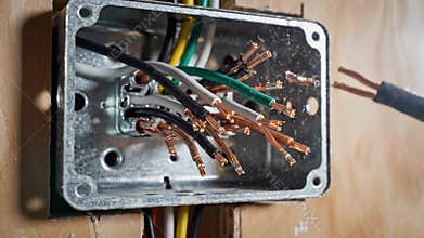 Electrical Repair Scene. Detailed View Of Exposed Cables In Electrical Junction Enclosure. Scene Showing Technician