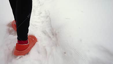 A woman runs through the snow.