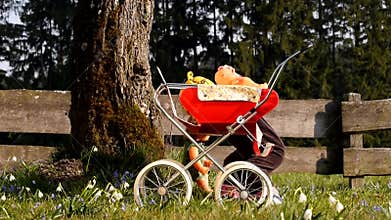 Child Playing With Doll Carriage