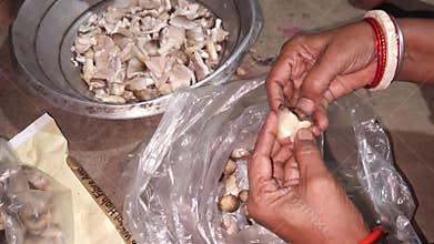 Close-up of hands cleaning fresh mushrooms for cooking, India