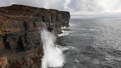 Huge waves crash against sea cliffs in Orkney