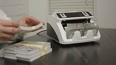 Banker counting cash in office. Banker controlling money and verifying dollars. Banker working in office with dollar bills