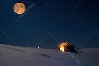Winter landscape with a starry sky and the full moon.