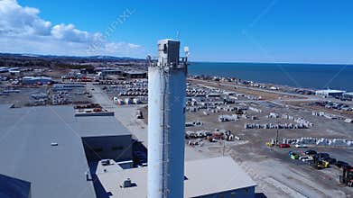 Drone Approaches Industrial Silo at Coastal Port in Quebec, Canada
