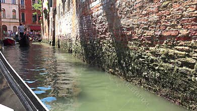 Gondola glides through Venice canal with romantic travel mood classic water transport detail, boat, along, carries, venetian