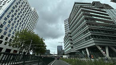Upward view of modern office towers framing cloudy sky in urban business