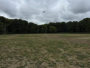 Commercial Airplane Flying Over Amsterdam Forest Under Cloudy Sky Netherlands