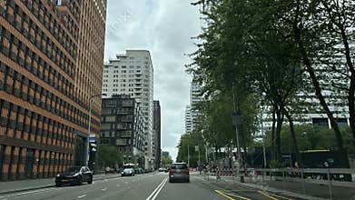 Modern city street in Amsterdam Zuid lined with tall office towers, apartment