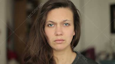 Young woman looking Sceptically and Disapproving into the camera