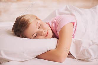 Young woman sleeping in bed