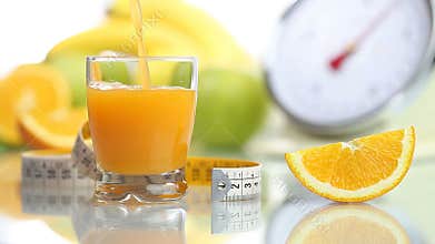 Orange juice poured in glass, fruit meter scales diet food