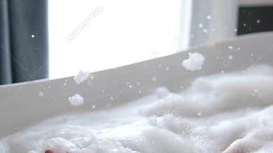 Relaxing bubble bath foam playful spa moment closeup bathroom soft light