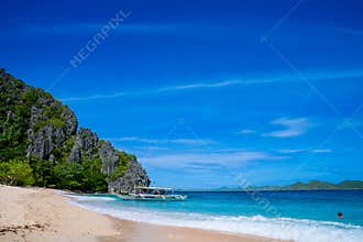 Pristine White Sand Beach with Traditional Bangka Boats in Palawan, Philippines