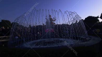 Silhouette of Goddess Durga Statue with Fountain at Sunset, Vrindavan Temple India Spiritual Scene