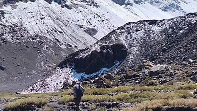 Man stoof in a valley by the Andes mountains