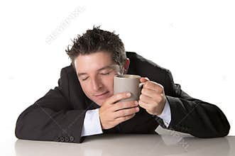Sleepy addict businessman holding take away coffee in caffeine addiction
