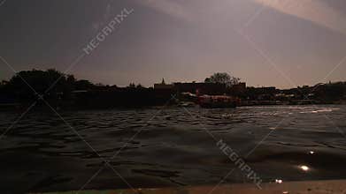 Boats on river at golden sunset India scenic water reflection evening travel landscape cinematic view