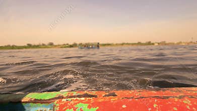 Peaceful sunset boat ride on river India scenic reflection evening travel background
