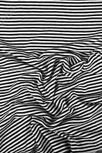Striped wrinkled black and white zebra fabric cloth background